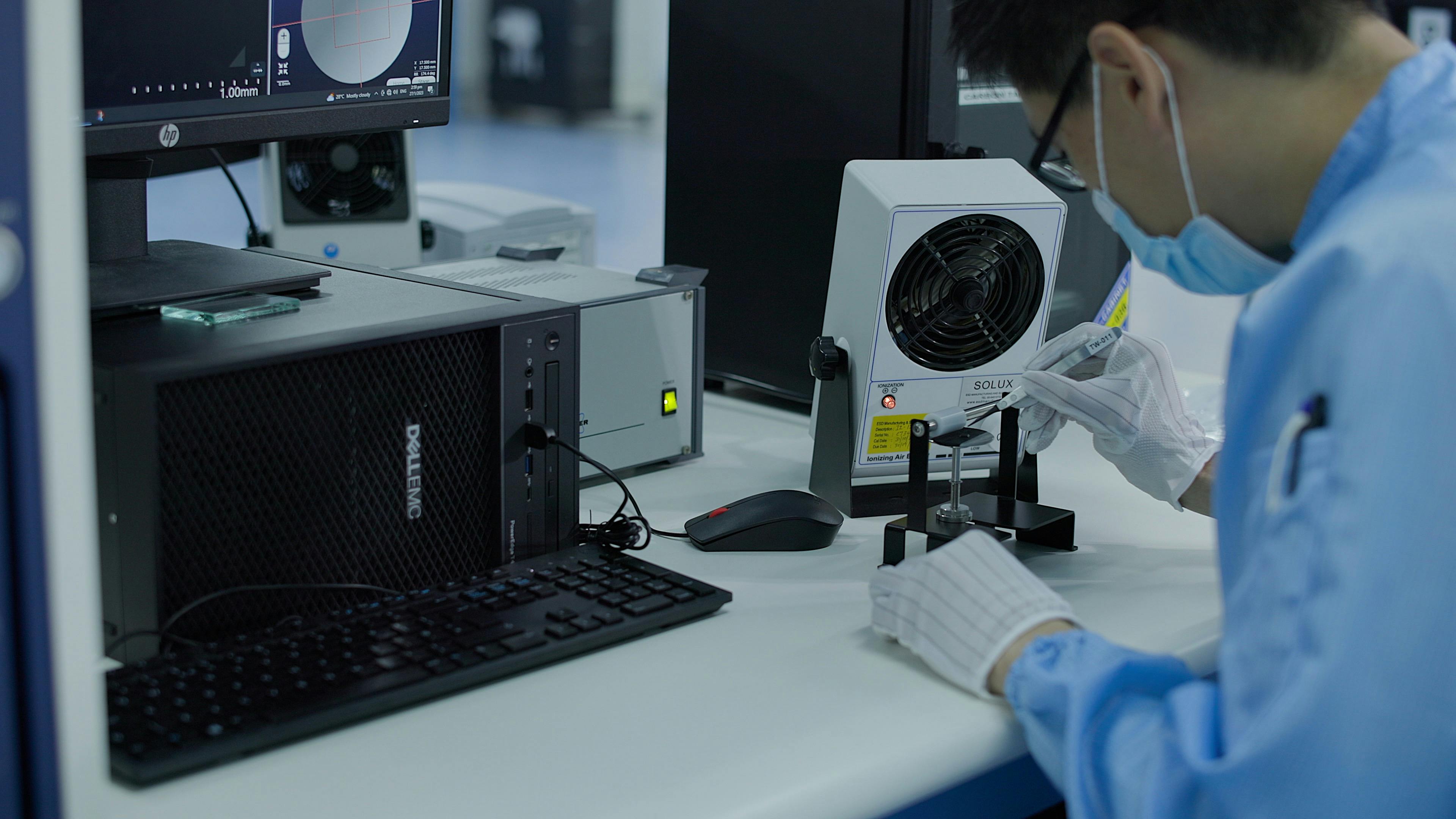 Fusion engineer working on a microchip at his desk