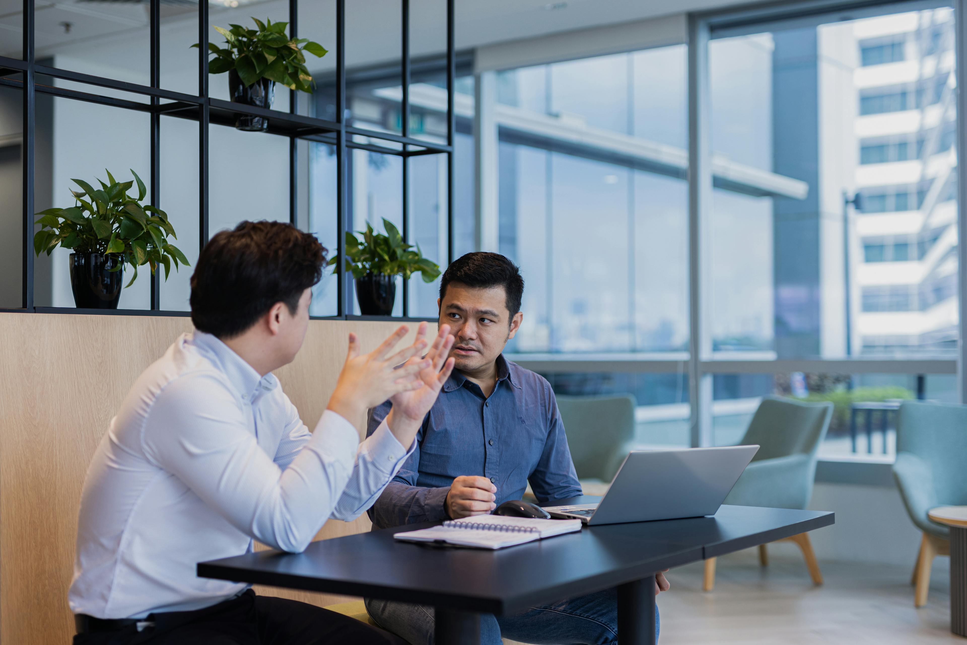 Two people talking in a common area at Fusion Worldwide's APAC office