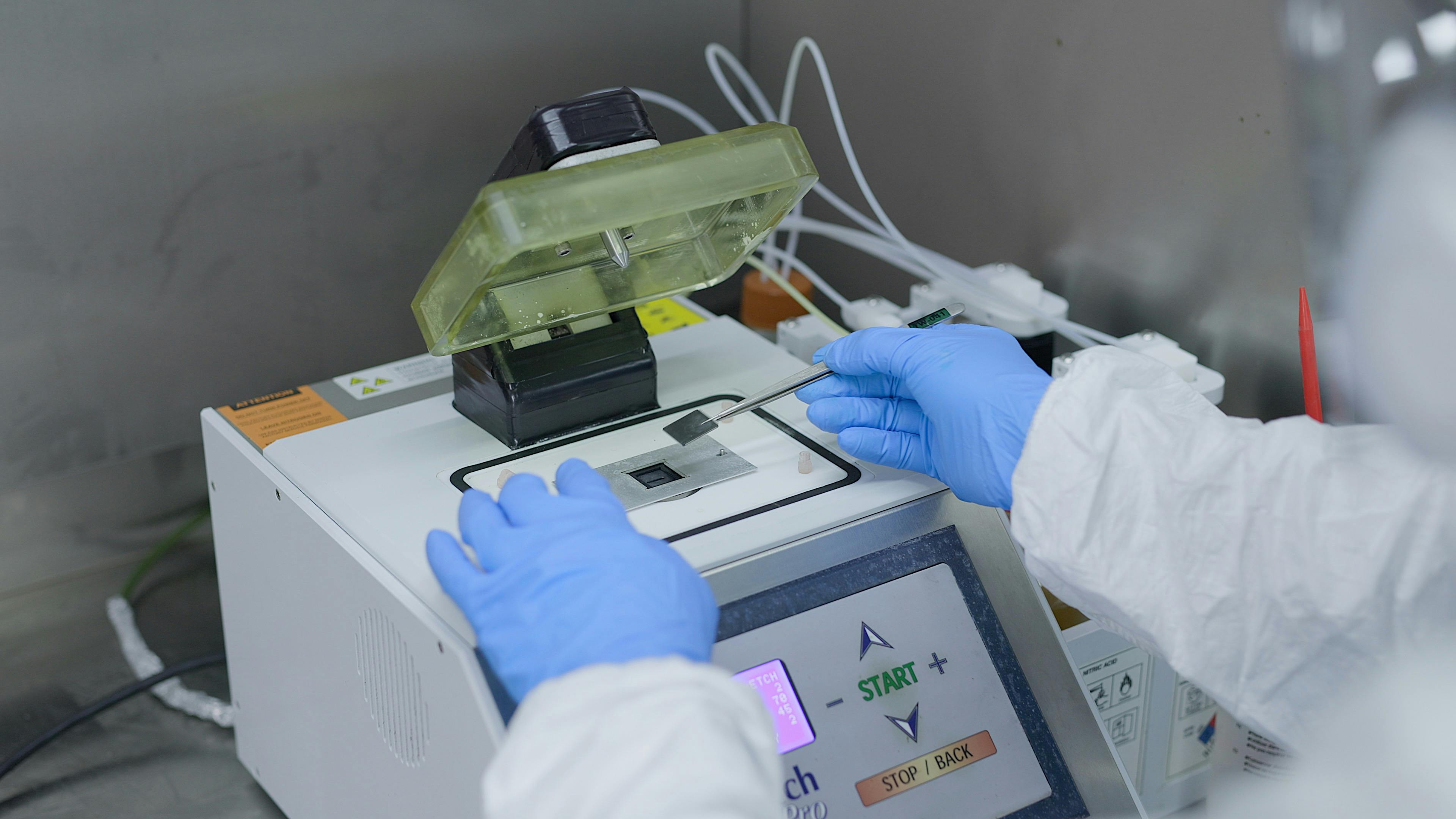 Fusion quality control inspector placing a microchip on a machine